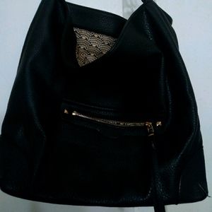 Black vegan leather hobo bag.